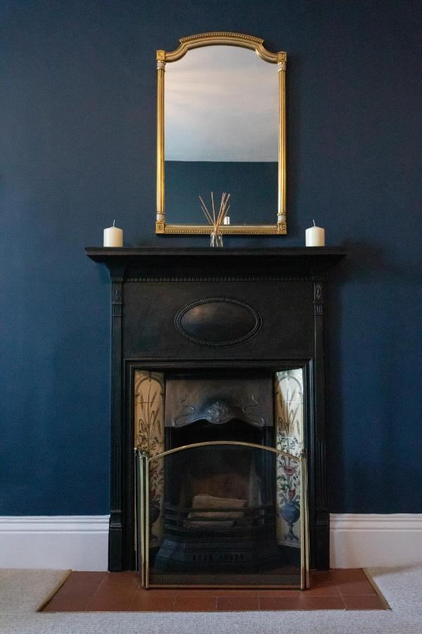Victorian fireplace with gold mirror