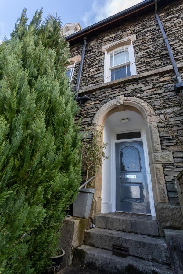 Stone entrance of Ashleigh House with blue front door